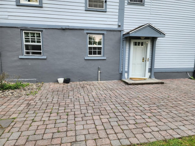 48 S St, Goshen, NY 10924 - view of exterior entry with a patio and stucco siding