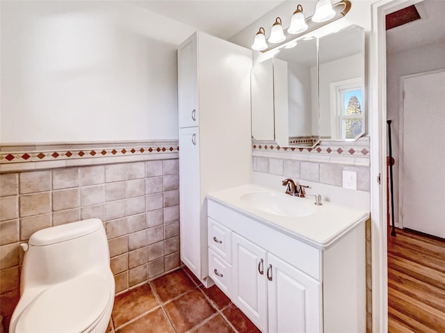 1 Charter Ln, Smithtown, NY 11787 - half bath featuring vanity, tile walls, toilet, and wainscoting