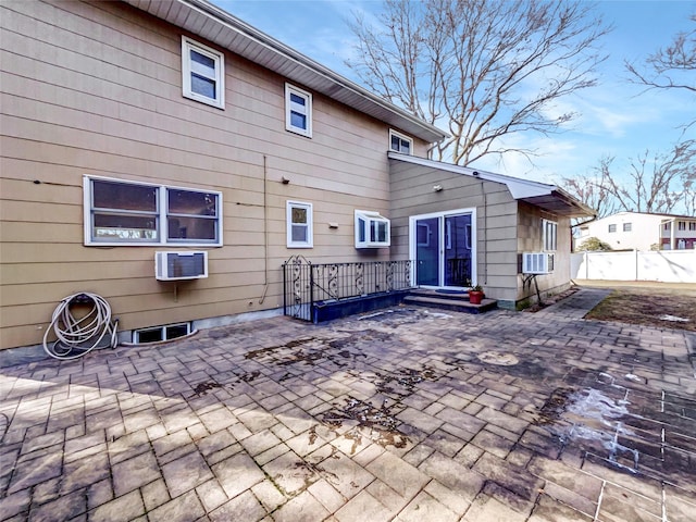 1 Charter Ln, Smithtown, NY 11787 - rear view of house with an AC wall unit, a patio area, and fence