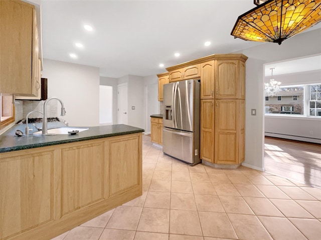1 Charter Ln, Smithtown, NY 11787 - kitchen featuring dark countertops, light brown cabinets, baseboard heating, stainless steel refrigerator with ice dispenser, and a sink