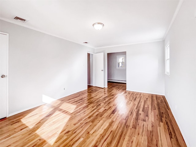1 Charter Ln, Smithtown, NY 11787 - spare room with a baseboard heating unit, wood finished floors, and ornamental molding