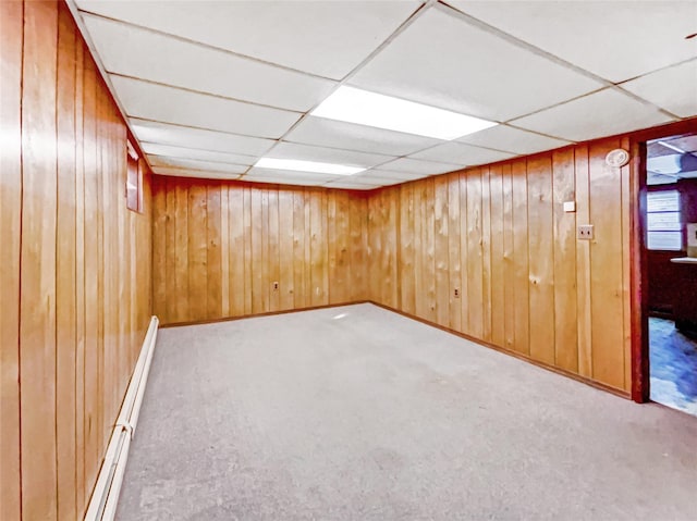 1 Charter Ln, Smithtown, NY 11787 - finished basement featuring a paneled ceiling, baseboard heating, wood walls, and carpet