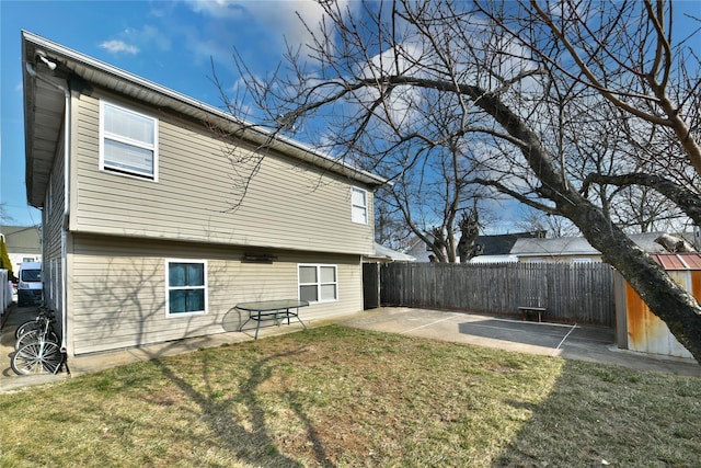 back of property featuring a fenced backyard, a lawn, and a patio