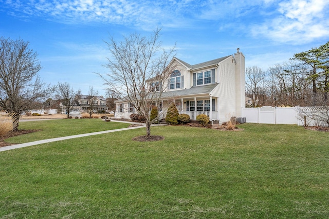 view of front of property featuring central AC unit, fence, covered porch, a chimney, and a front lawn