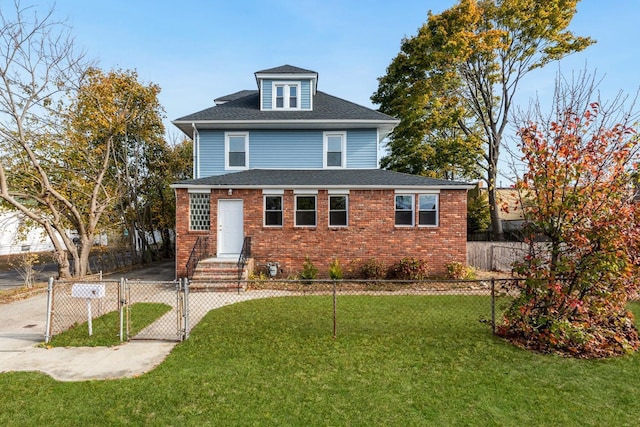 traditional style home featuring a fenced front yard, brick siding, a front lawn, and a gate