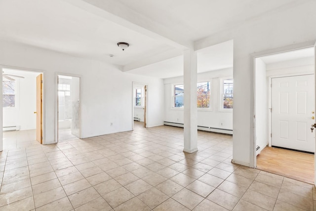 unfurnished room featuring light tile patterned floors, a baseboard heating unit, and a baseboard radiator