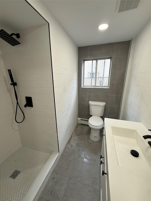 bathroom featuring visible vents, a shower stall, toilet, vanity, and a baseboard radiator