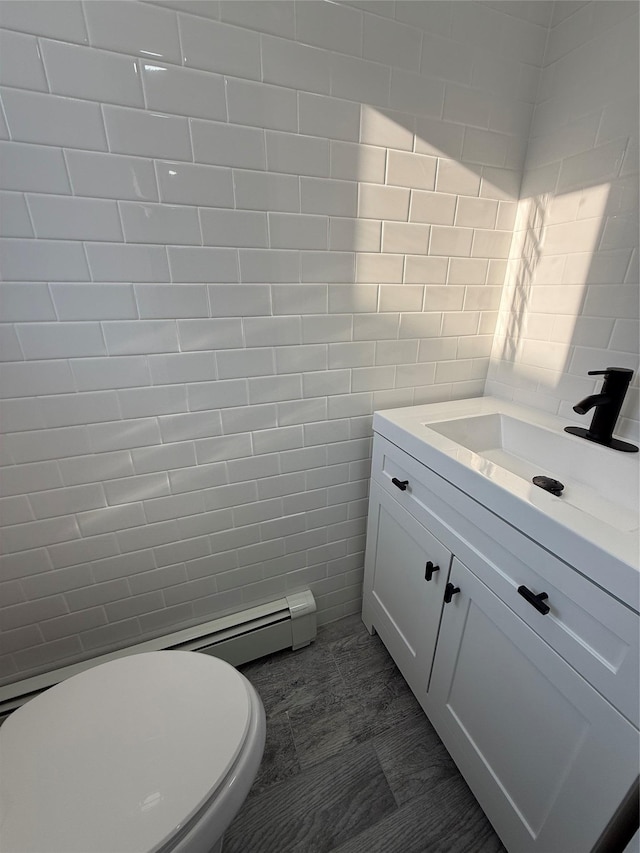 bathroom featuring vanity, tile walls, and toilet