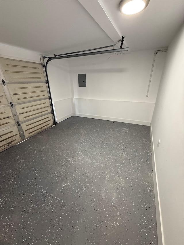 garage with electric panel and baseboards