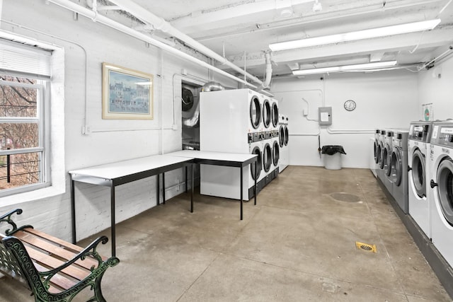 below grade area featuring separate washer and dryer and stacked washing maching and dryer