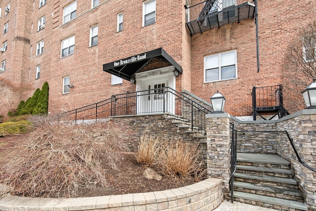 doorway to property featuring brick siding