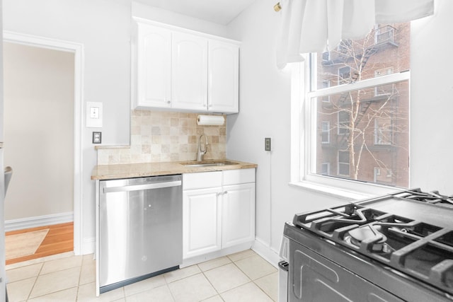 kitchen featuring a sink, backsplash, white cabinetry, and stainless steel appliances