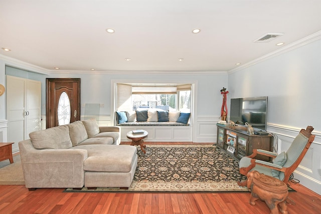 living room with visible vents, a wainscoted wall, a healthy amount of sunlight, and wood finished floors