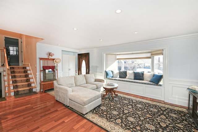 living area featuring crown molding, stairs, recessed lighting, wainscoting, and light wood-style floors