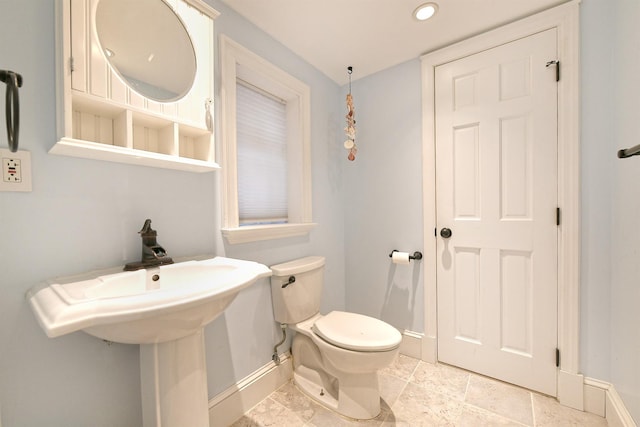 half bath with recessed lighting, toilet, and baseboards