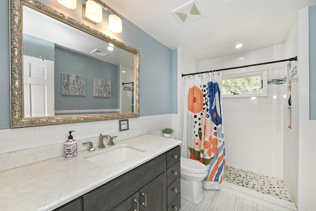 bathroom with visible vents, curtained shower, toilet, and vanity