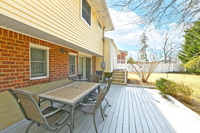 deck with outdoor dining area and fence