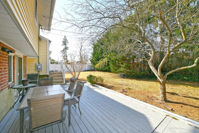 wooden terrace featuring outdoor dining area and fence