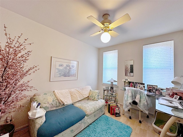 home office with wood finished floors and a ceiling fan