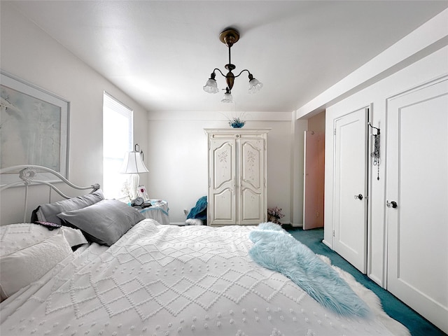 bedroom with a notable chandelier and light colored carpet