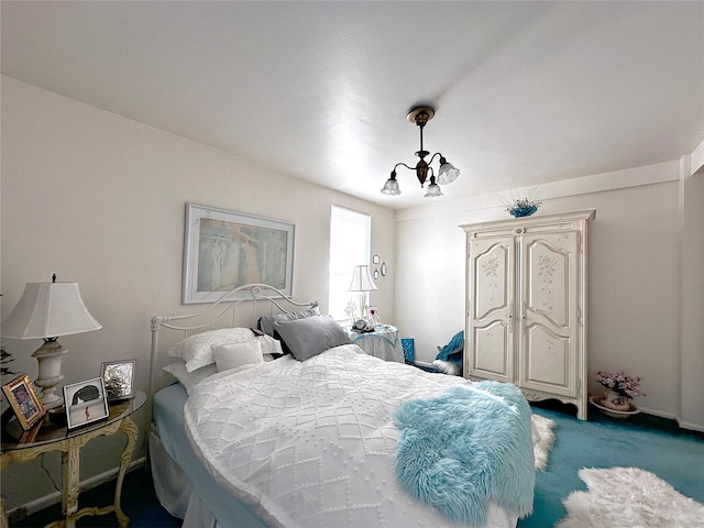 bedroom featuring a notable chandelier and carpet floors