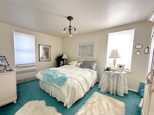 bedroom featuring radiator, baseboards, and carpet floors