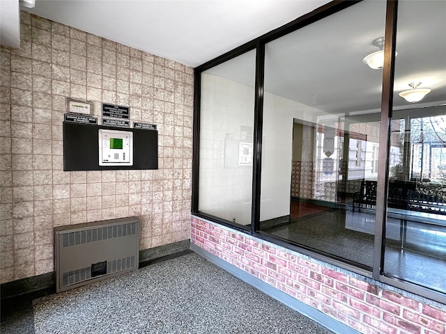 interior space featuring radiator and baseboards