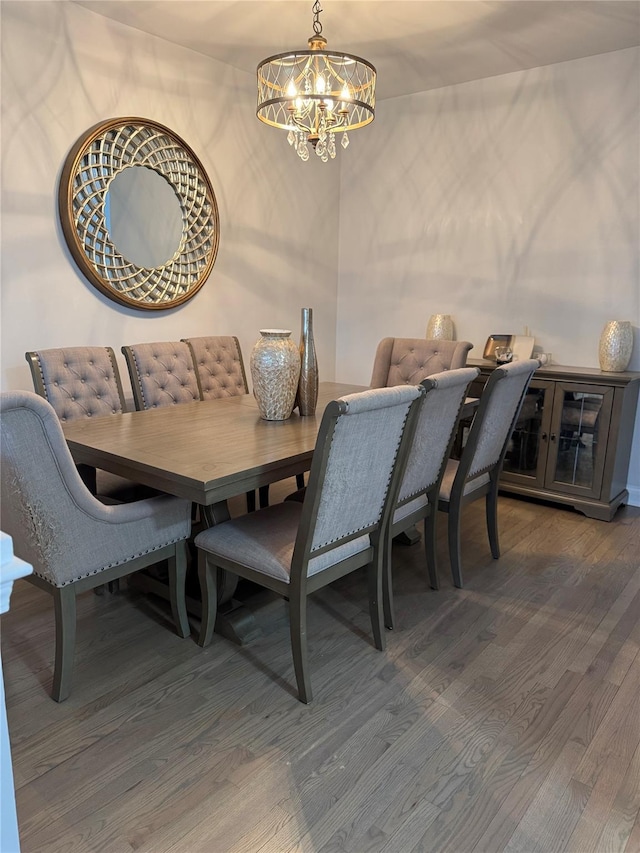 dining area featuring wood finished floors and a chandelier