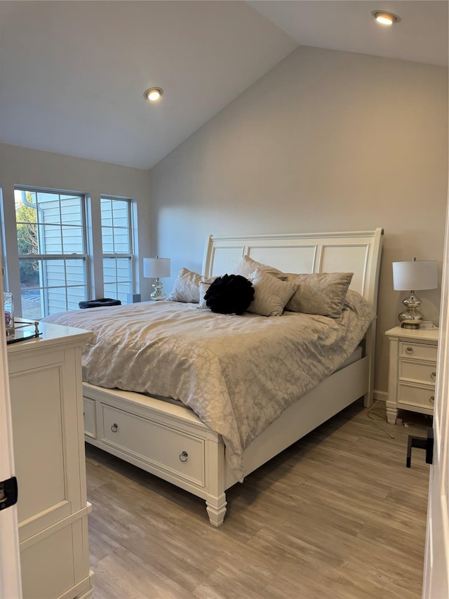 bedroom featuring lofted ceiling, light wood-style flooring, and recessed lighting