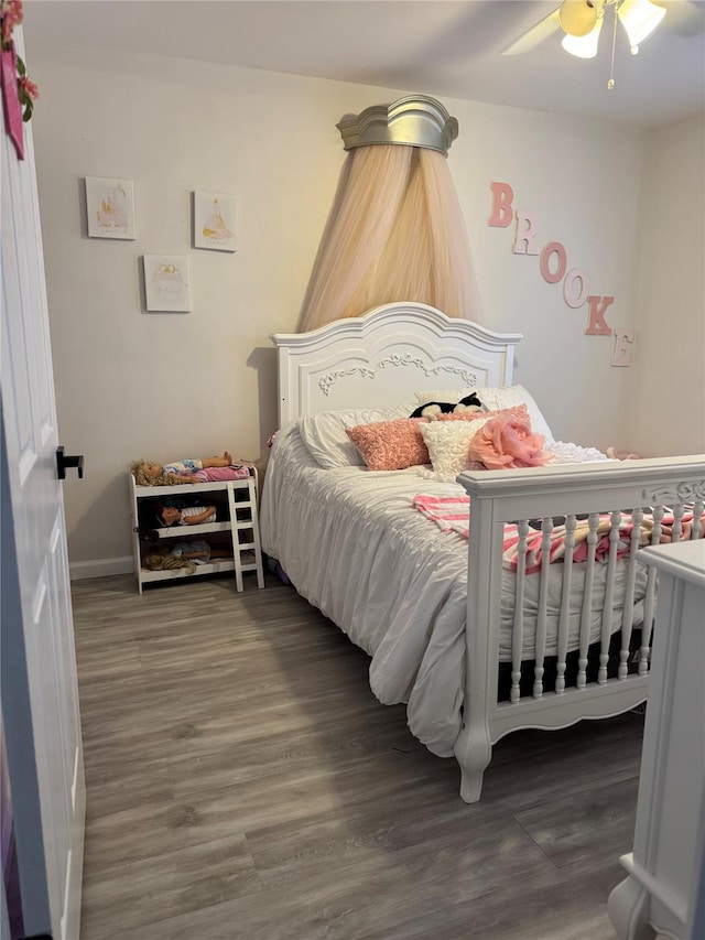 bedroom featuring a ceiling fan and wood finished floors