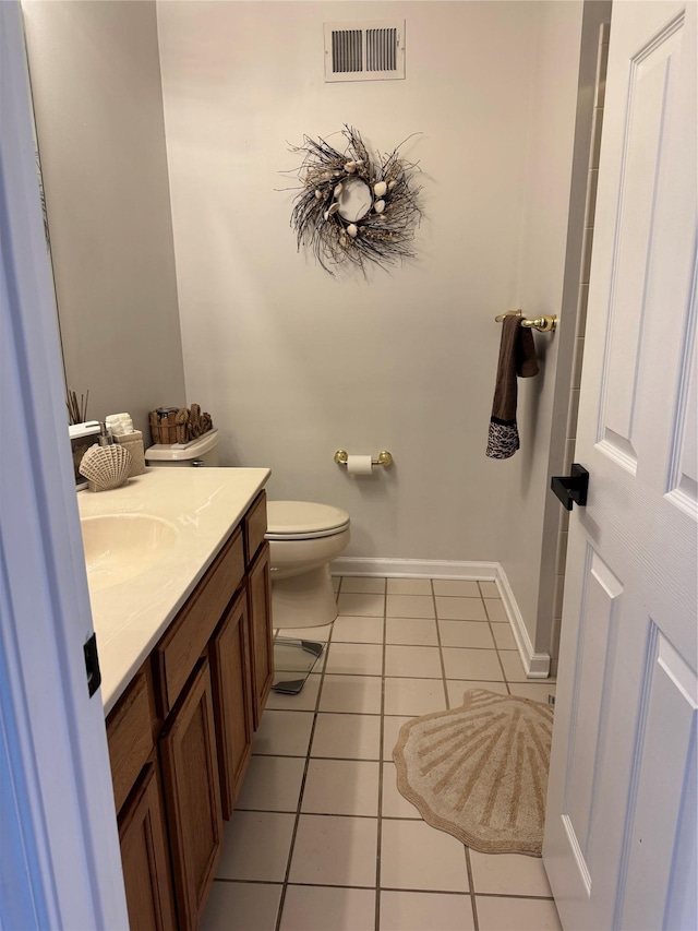 bathroom with tile patterned flooring, visible vents, baseboards, toilet, and vanity