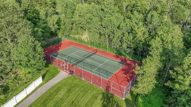 view of sport court featuring a yard and fence