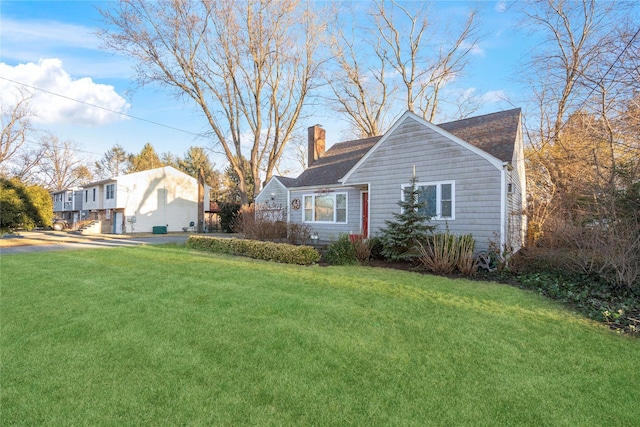 back of house featuring a lawn and a chimney