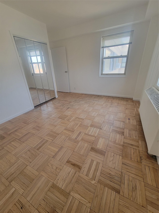 unfurnished room featuring baseboards