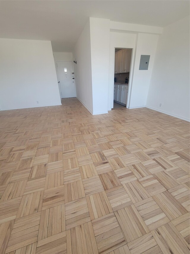 unfurnished room featuring electric panel