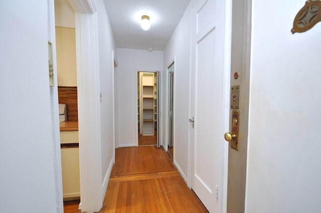hall with wood finished floors