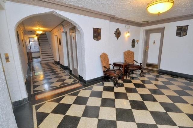 corridor with arched walkways, a textured ceiling, ornamental molding, and stairs