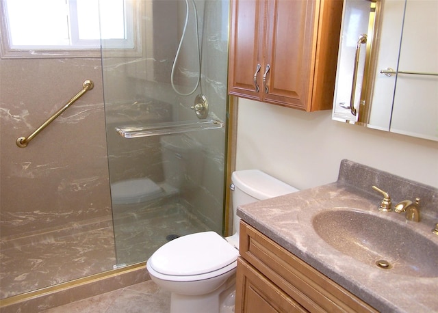 bathroom featuring a stall shower, toilet, and vanity