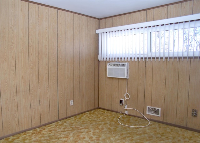 unfurnished room featuring carpet flooring, wood walls, an AC wall unit, and visible vents