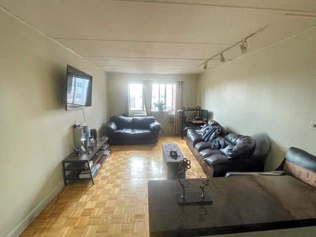 living room featuring track lighting and baseboards