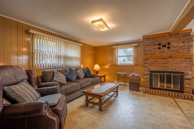 living room with wooden walls, baseboard heating, a fireplace, and crown molding