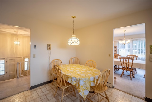 dining area featuring a notable chandelier, baseboards, and light carpet