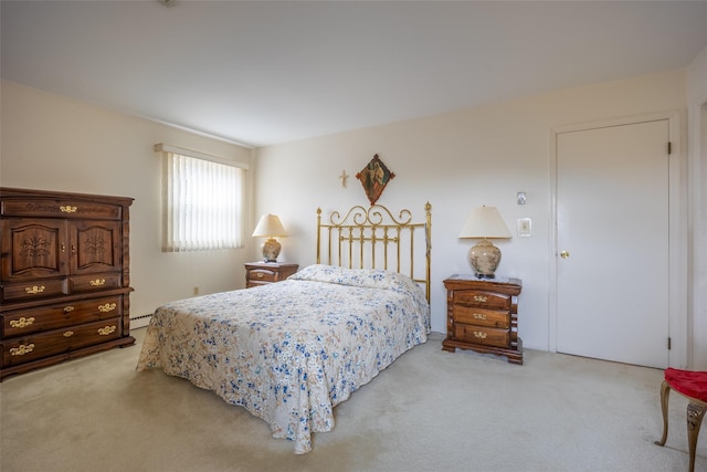 bedroom featuring baseboard heating and light colored carpet