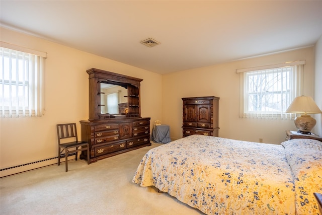 bedroom with visible vents, multiple windows, baseboard heating, and carpet floors