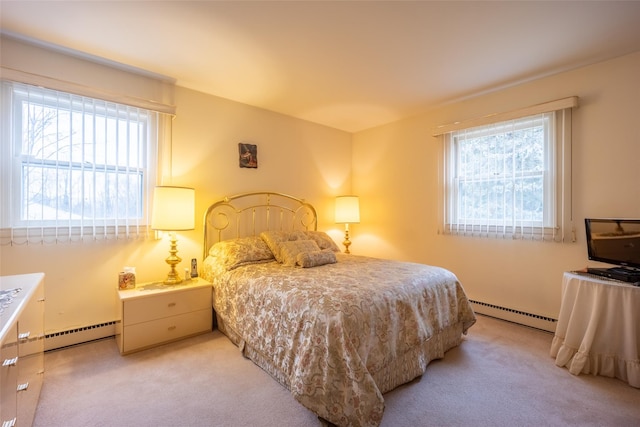 bedroom with light colored carpet and a baseboard radiator