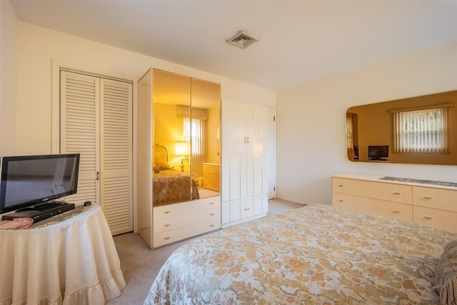 bedroom with visible vents and light colored carpet