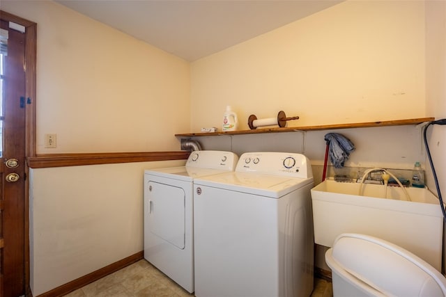 laundry room with baseboards, washing machine and dryer, and laundry area