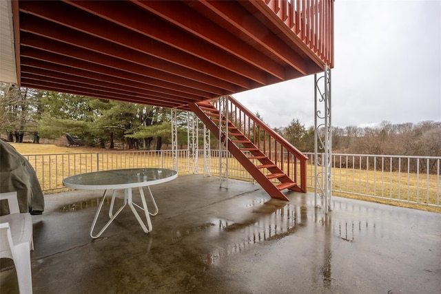 view of patio / terrace featuring stairs and fence