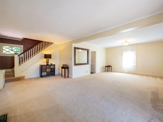 679 Saint Lukes Pl, Baldwin, NY 11510 - unfurnished living room with stairs, carpet flooring, and baseboards