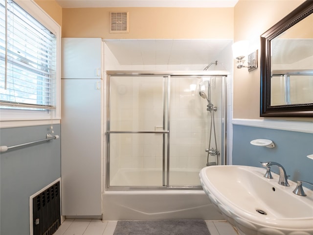 679 Saint Lukes Pl, Baldwin, NY 11510 - bathroom featuring tile patterned floors, a sink, enclosed tub / shower combo, and radiator